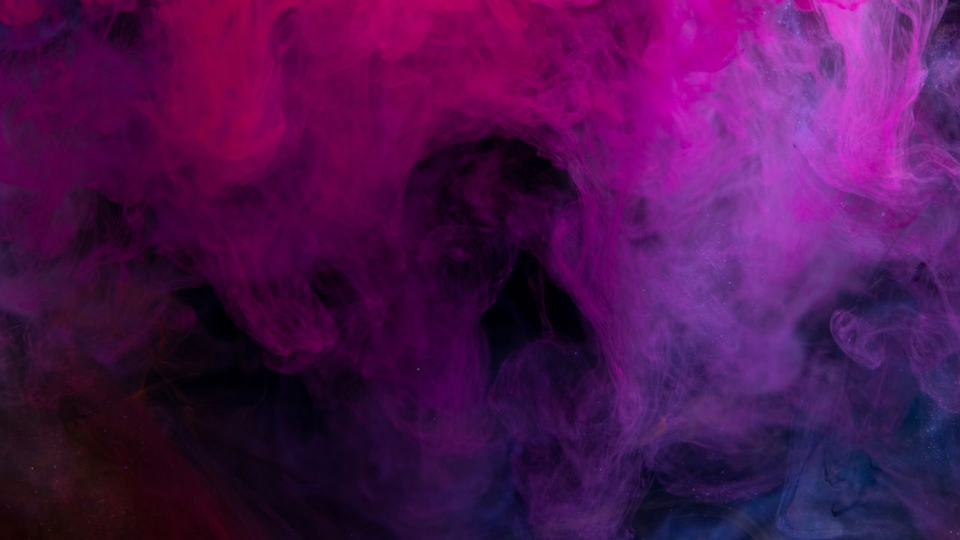 Vibrant purple and pink smoke swirling in abstract, ethereal patterns